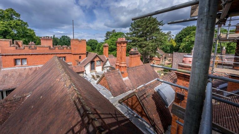 A view from the scaffolding during year 3 of the Big MEND project at Wightwick Manor, looking out over the rooftops with a view of the intricate barley twist chimneys.
